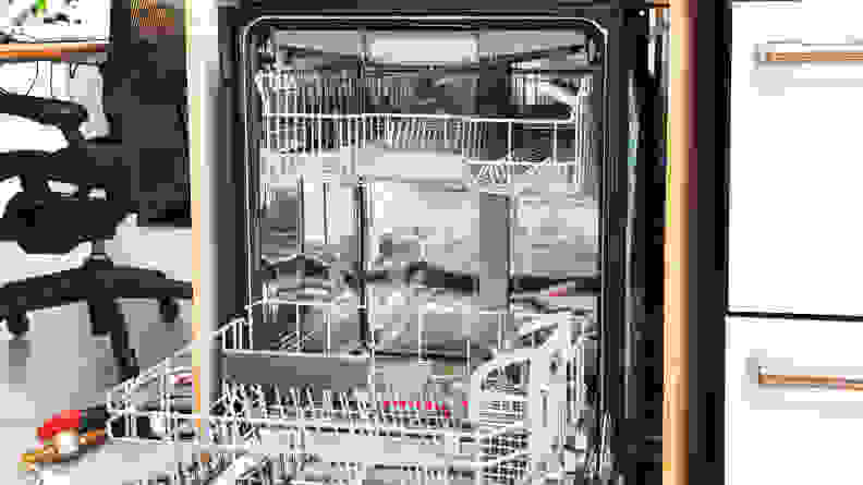 The Bosch SHP78CM5N with the door open, and dishes on a the top and bottom rack.