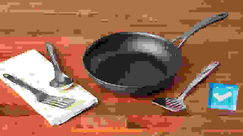 Metal utensils on a white napkin, next to the Circulon ScratchDefense cookware.