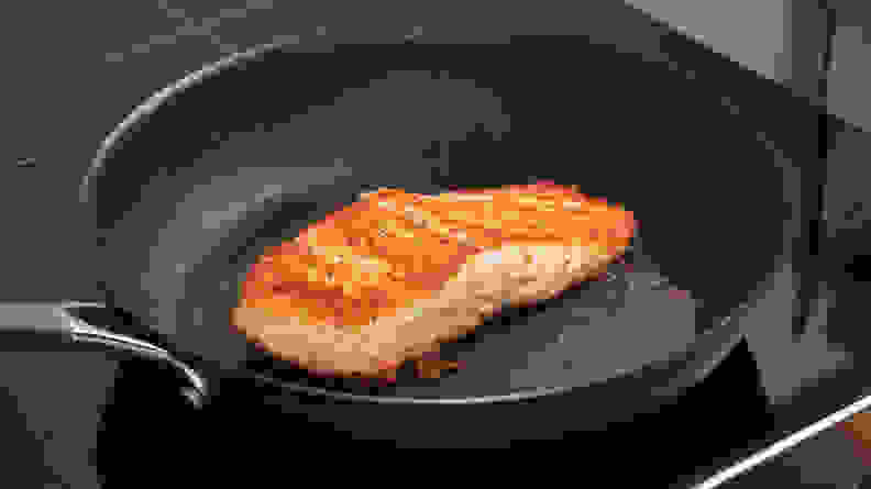 Salmon cooking on the Circulon ScratchDefense pan.