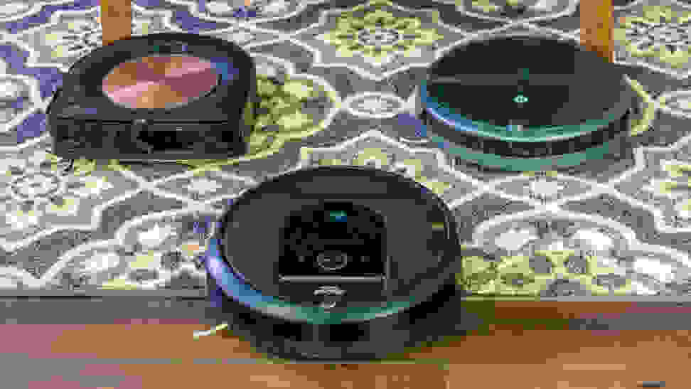 The iRobot Roomba i7+, S9+, and 694 on carpet.