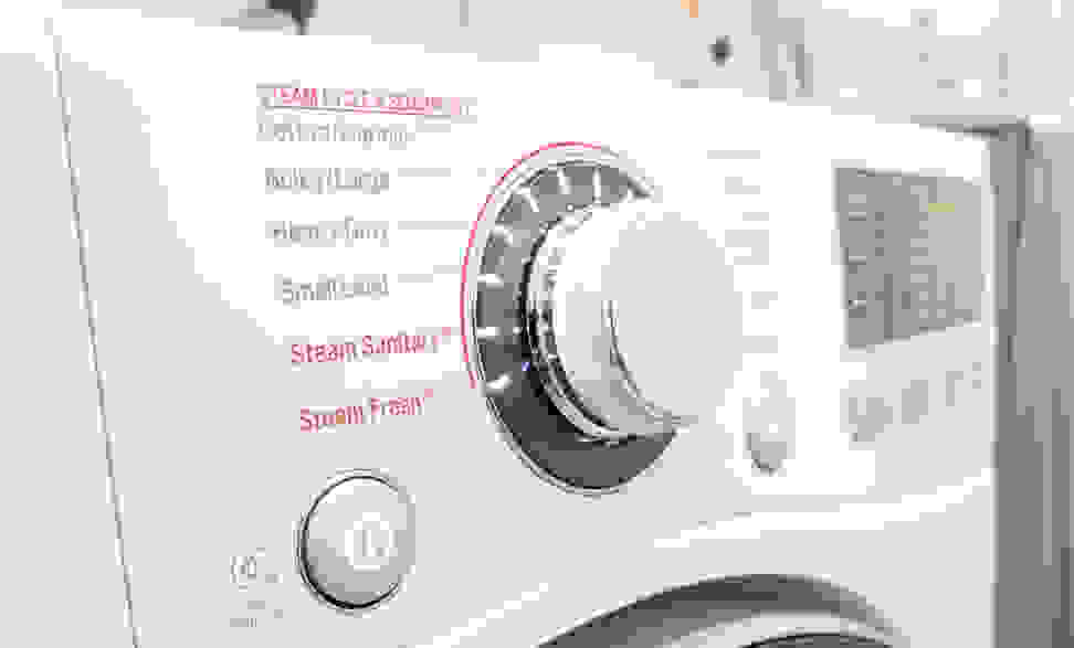 A control panel shows cycle options on the front control panel of a white dryer