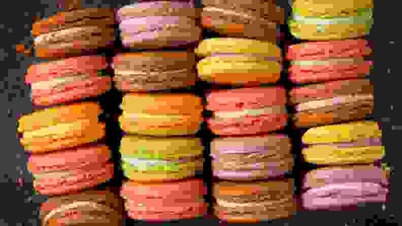 Four rows of colorful French macarons shot from above