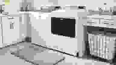 A white washing machine and dryer sit in a laundry room