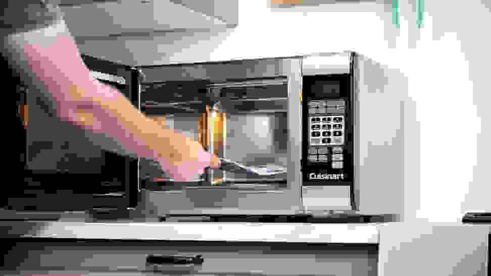 Placing a popcorn bag in a microwave