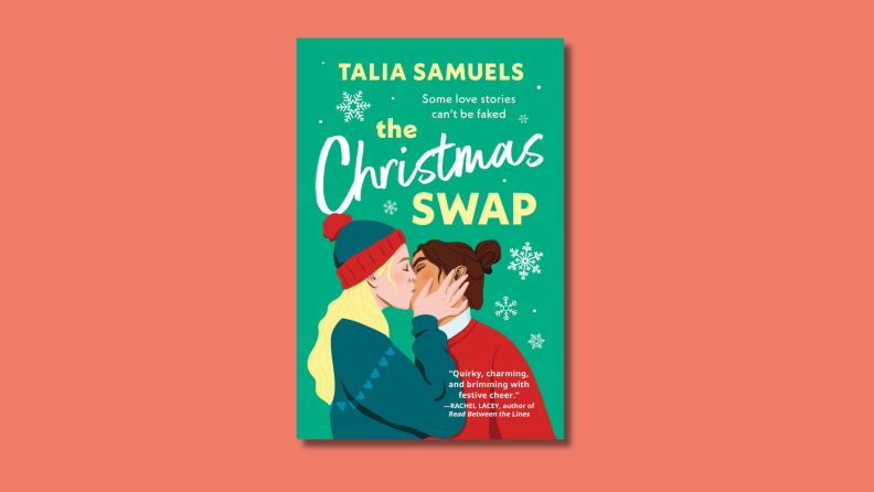 An image of the cover of "The Christmas Swap" by Talia Samuels, which features two women in Christmas sweaters kissing.