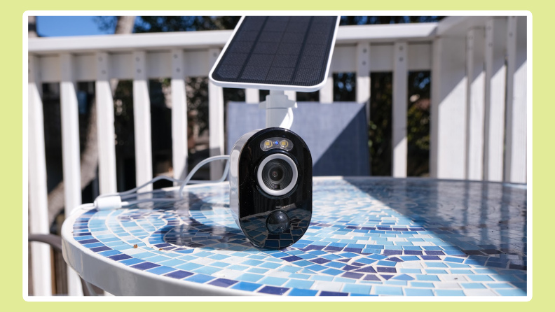 The Reolink Argus 3 Pro with solar panel sitting on a table outside