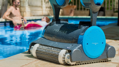 Close-up of a blue and gray Dolphin Premier robot pool vacuum.