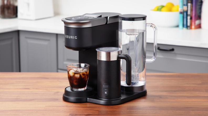 The Keurig K-Cafe Smart shown on a kitchen counter with a glass of iced coffee prepared.