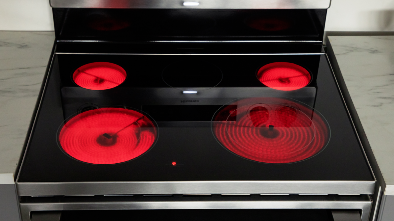 Four heated burners lit up on the Hisense HBE3501CPS 30-in Freestanding Electric Range.