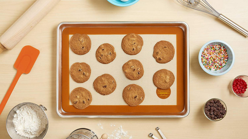 A Silmat mat covered with cookies on baking sheet