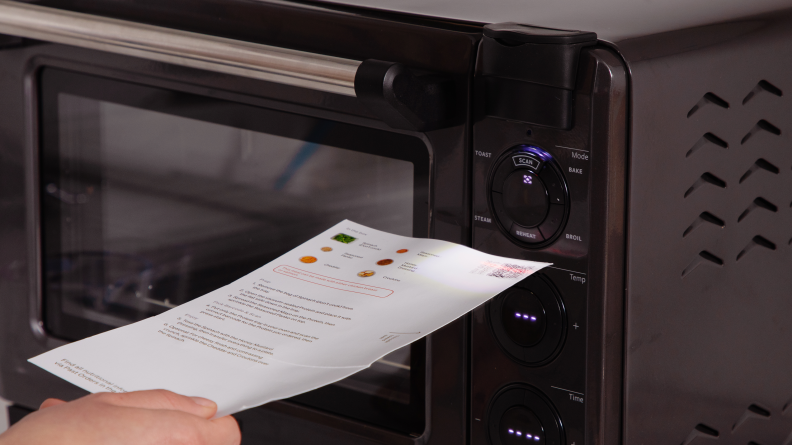 A person scanning a Tovala recipe card on the Smart Oven Pro.