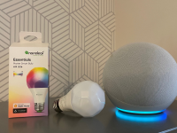 An Amazon Echo speaker sits next to a Matter-enabled Nanoleaf smart bulb and its packaging