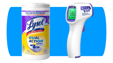 Lysol wipes and white thermometer on blue background